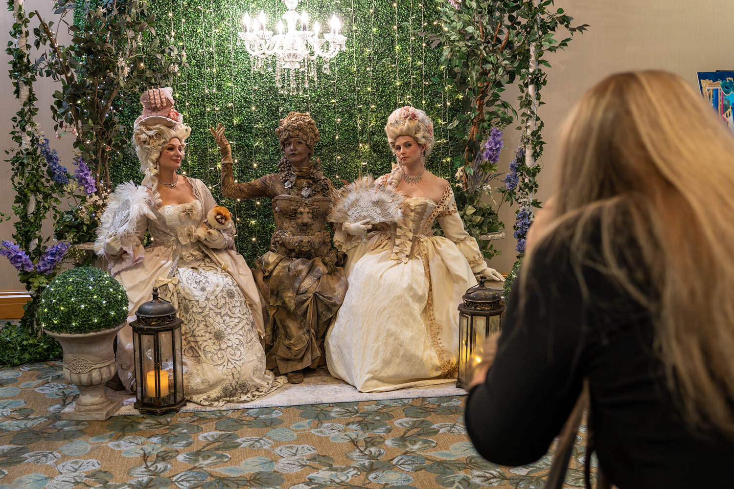 Three elaborate human statues dressed in Rennaissance garb at the 65 Roses gala.