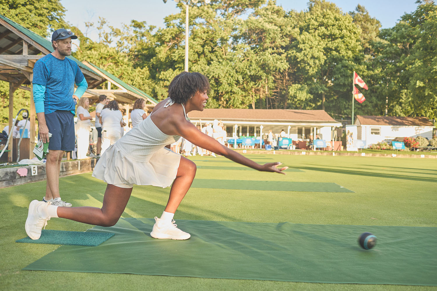 A LSN participant throw a lawn bowling ball down the green.